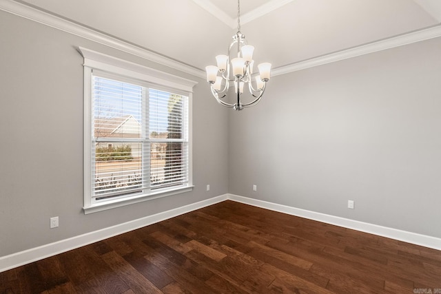 empty room featuring hardwood / wood-style floors, crown molding, and a chandelier