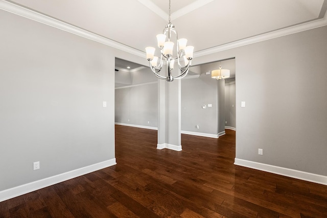 unfurnished dining area featuring ornamental molding, dark hardwood / wood-style floors, and a notable chandelier