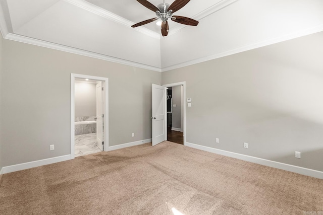 unfurnished bedroom with a towering ceiling, carpet, ceiling fan, crown molding, and ensuite bath