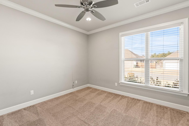 carpeted spare room featuring crown molding and ceiling fan