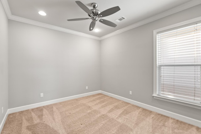 unfurnished room with ornamental molding, carpet flooring, and ceiling fan