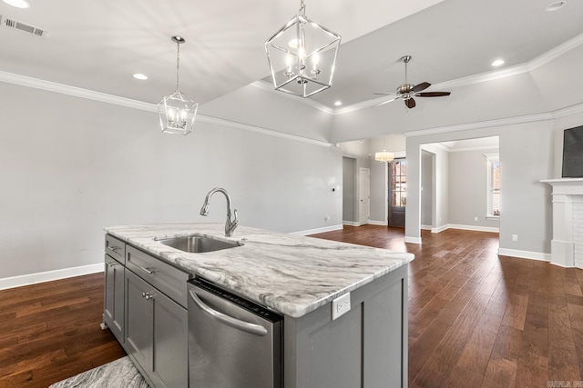 kitchen with gray cabinets, pendant lighting, sink, stainless steel dishwasher, and a center island with sink