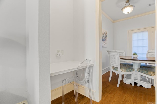 dining room featuring ornamental molding and hardwood / wood-style floors