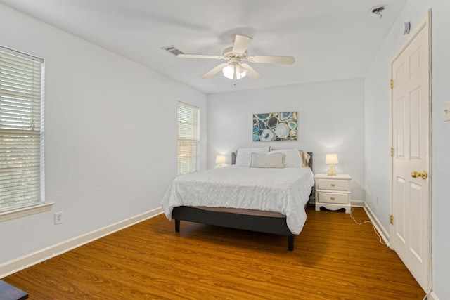 bedroom with hardwood / wood-style floors and ceiling fan