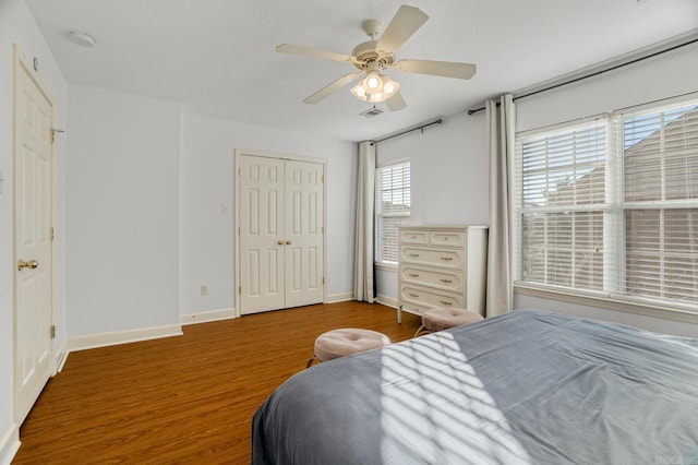 bedroom with wood-type flooring, a closet, and ceiling fan