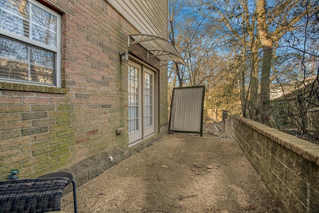 view of exterior entry featuring a patio