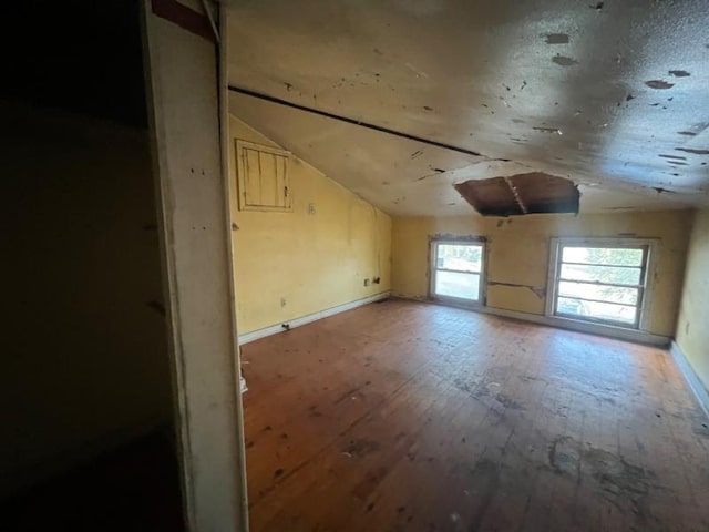 bonus room featuring wood-type flooring and vaulted ceiling