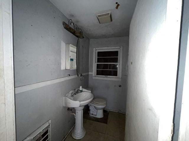 bathroom featuring toilet and tile patterned flooring