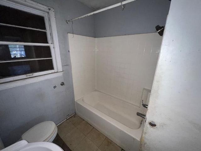 bathroom featuring toilet, shower / bath combination, and tile patterned flooring