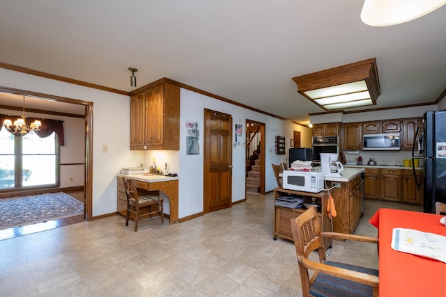 kitchen featuring decorative light fixtures, black refrigerator, wall oven, a notable chandelier, and crown molding