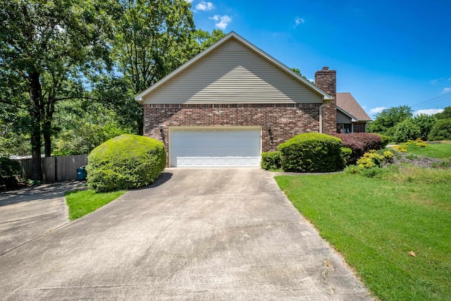 view of front of house featuring a garage and a front lawn