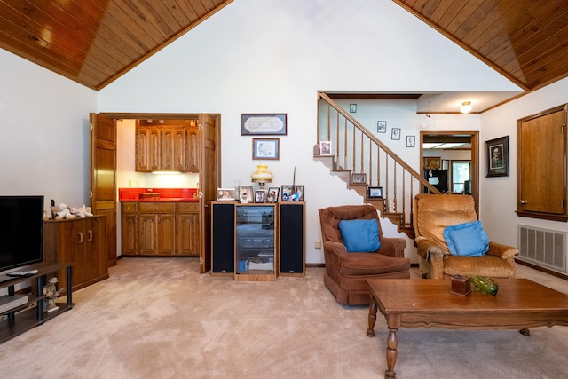 living room with wooden ceiling, light colored carpet, and high vaulted ceiling