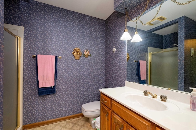 bathroom with a shower with door, toilet, and vanity