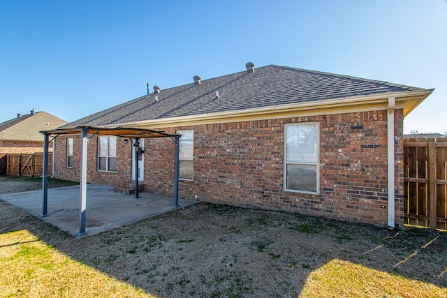 rear view of property with a patio and a lawn