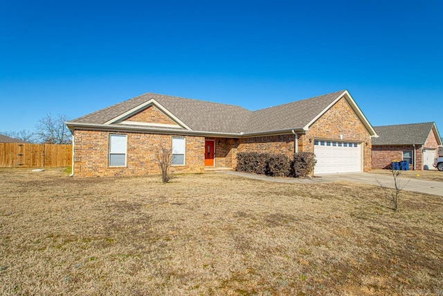 ranch-style home featuring a garage and a front lawn