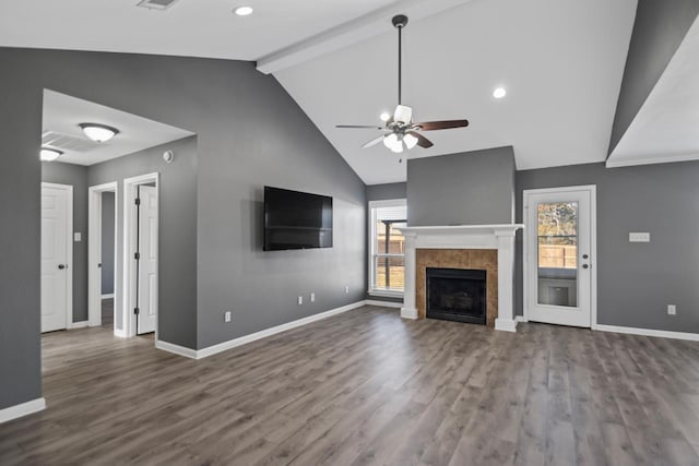 unfurnished living room with a fireplace, hardwood / wood-style flooring, vaulted ceiling with beams, and ceiling fan