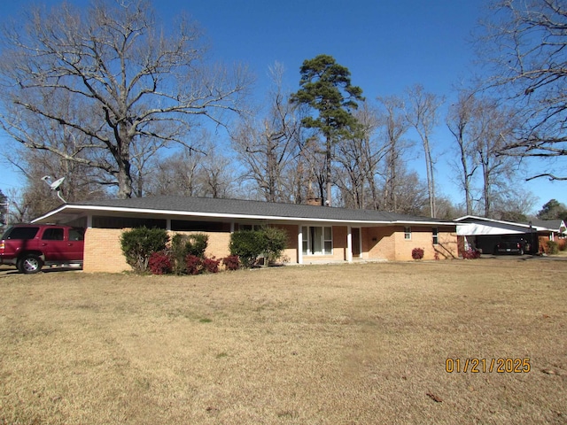 ranch-style home featuring a front yard and a carport