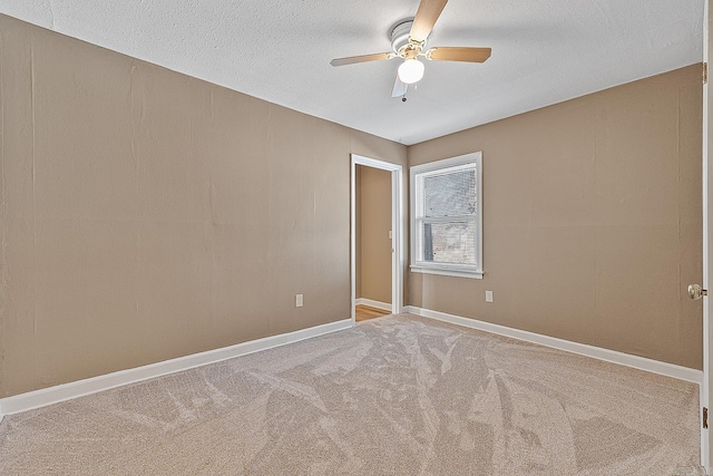 carpeted empty room with a textured ceiling and ceiling fan