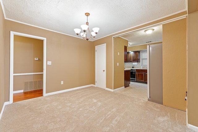 carpeted empty room featuring a notable chandelier, ornamental molding, beverage cooler, and a textured ceiling