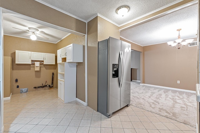 kitchen featuring crown molding, white cabinetry, stainless steel fridge with ice dispenser, ceiling fan with notable chandelier, and a textured ceiling