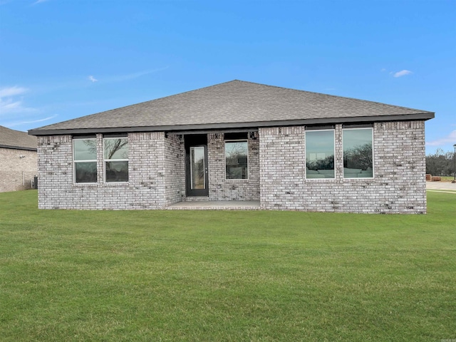 back of house with a lawn and a patio