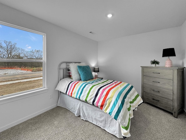 bedroom featuring light carpet