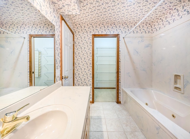 bathroom featuring a tub, tile patterned flooring, and vanity