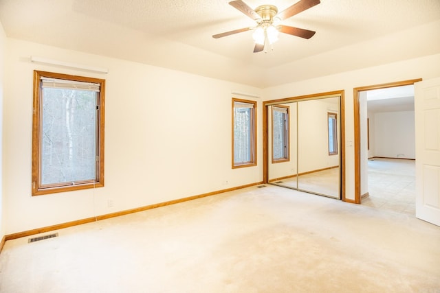 unfurnished room featuring ceiling fan and light colored carpet