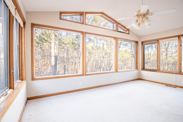 unfurnished sunroom featuring ceiling fan, plenty of natural light, and lofted ceiling