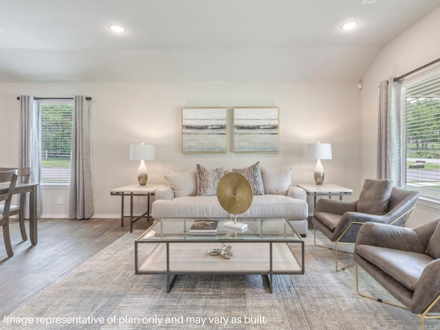 living room with vaulted ceiling, recessed lighting, wood finished floors, and baseboards