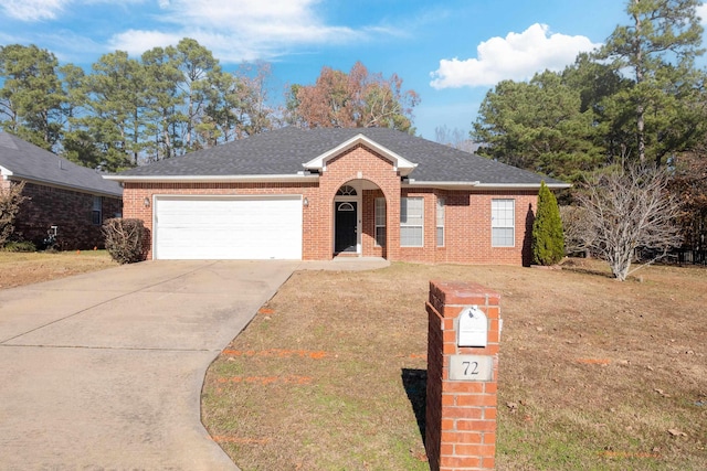 ranch-style home featuring a garage and a front lawn