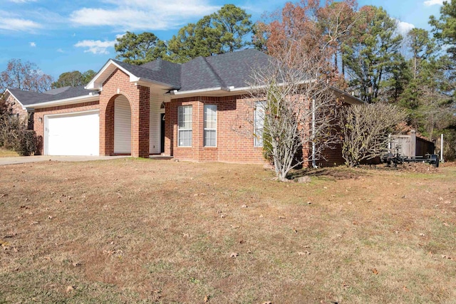 view of front of home with a garage and a front lawn