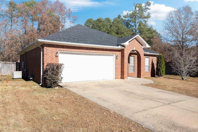 view of front of house featuring a garage and a front lawn