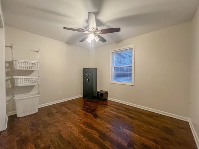 unfurnished room featuring ceiling fan and dark hardwood / wood-style flooring