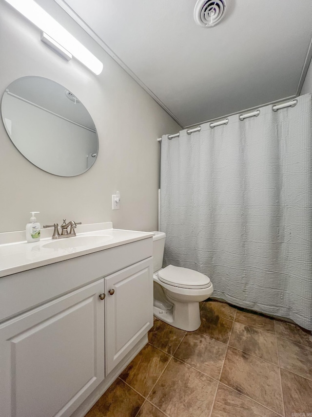 bathroom featuring toilet, vanity, and a shower with shower curtain