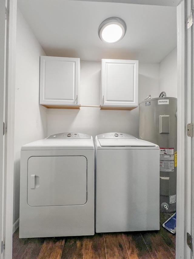 laundry area featuring cabinets, dark hardwood / wood-style flooring, water heater, and washing machine and clothes dryer