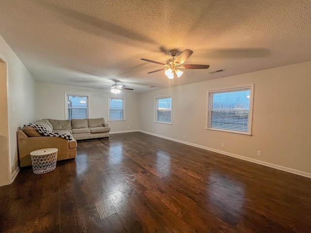 unfurnished living room featuring a textured ceiling, ceiling fan, and dark hardwood / wood-style flooring