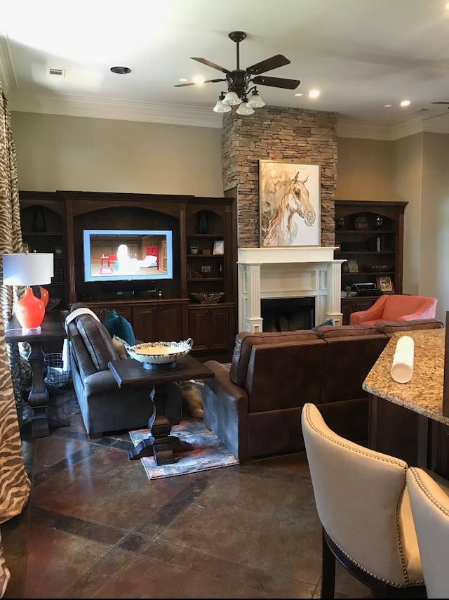 living room with ceiling fan, ornamental molding, and a fireplace