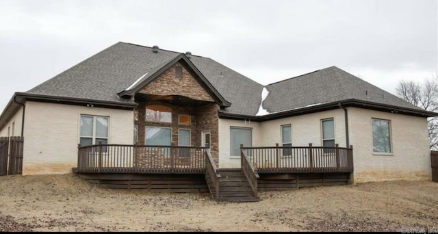 rear view of property featuring a wooden deck