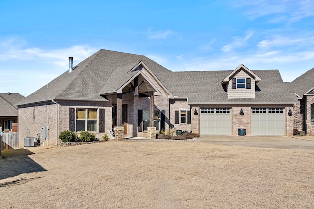 view of front facade featuring a garage and central AC unit