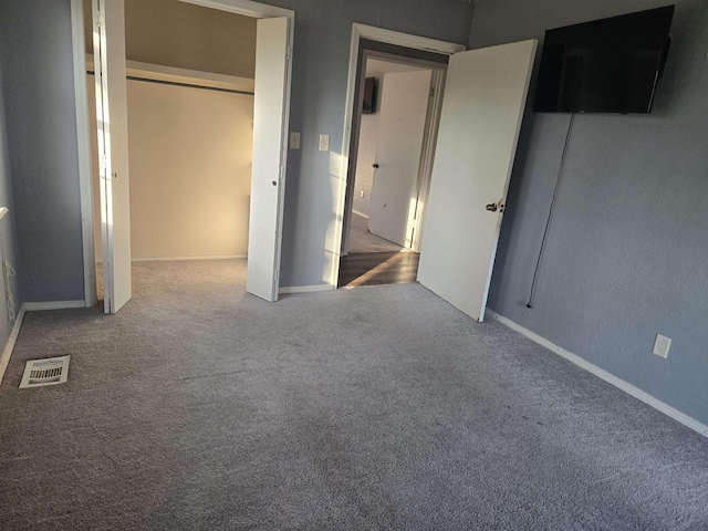 unfurnished bedroom featuring a closet and carpet flooring