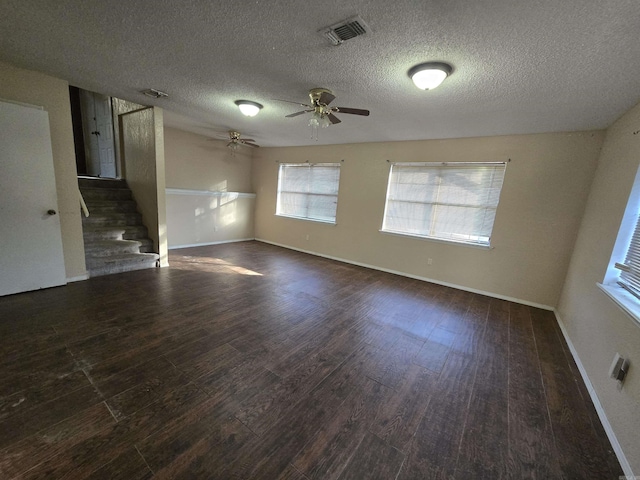 spare room with ceiling fan, dark wood-type flooring, and a textured ceiling