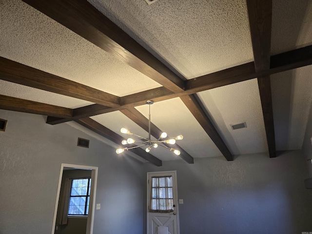 details with a textured ceiling, beamed ceiling, and a notable chandelier