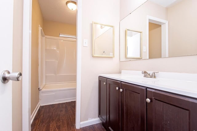 bathroom with vanity, shower / bathtub combination, and wood-type flooring