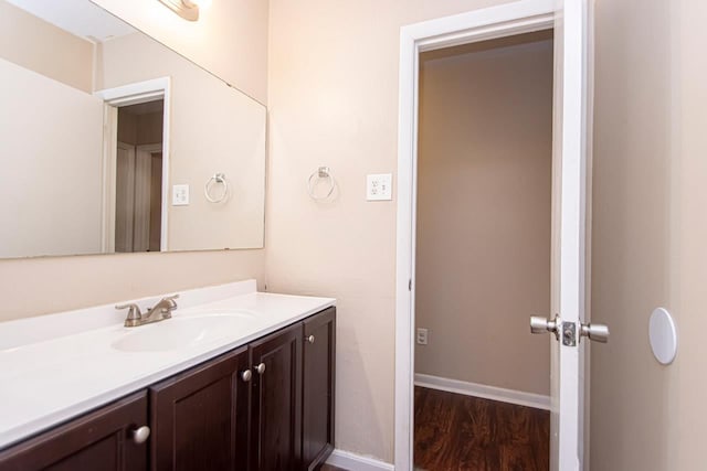 bathroom with hardwood / wood-style flooring and vanity