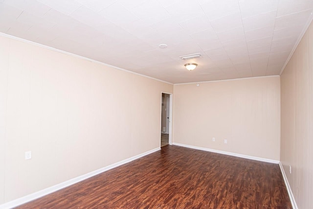 spare room featuring dark hardwood / wood-style flooring and ornamental molding