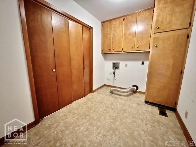 laundry room with hookup for a washing machine, hookup for an electric dryer, and cabinets