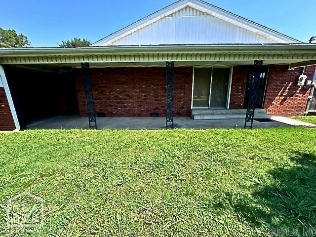 rear view of property with a lawn