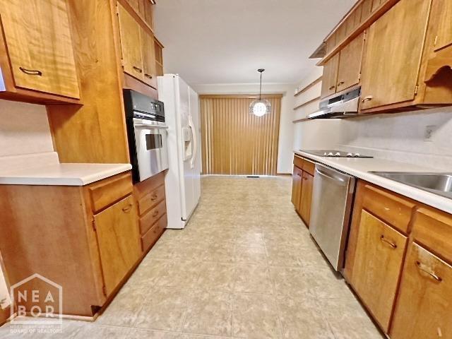 kitchen with decorative light fixtures and appliances with stainless steel finishes