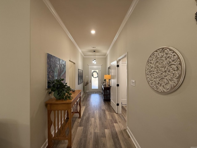 corridor with dark hardwood / wood-style flooring and ornamental molding